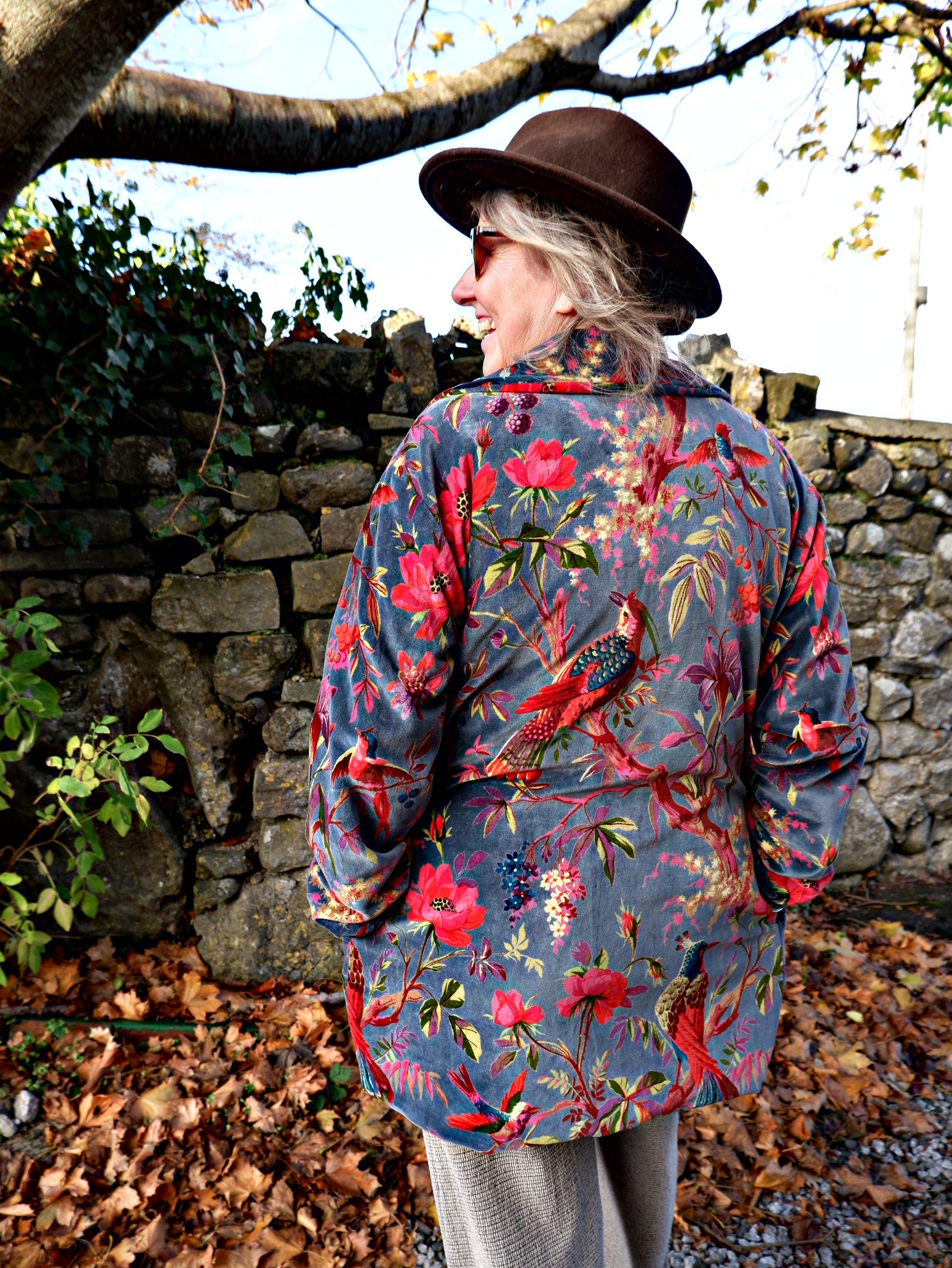 lady wearing floral velvet jacket with hat